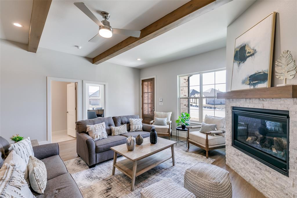 635 Community Lane Rockwall, TX 75087 - Photo 8 of 25 a living room with furniture a fireplace and a large window