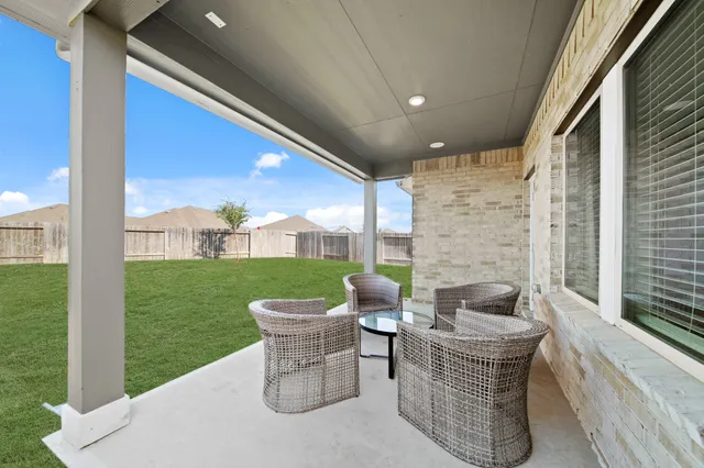 a view of a house with a yard and porch