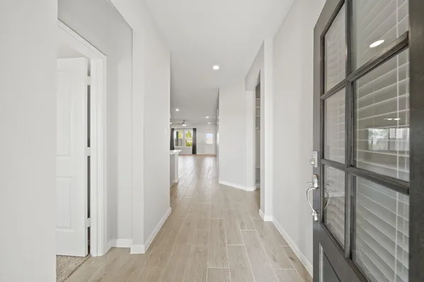 a view of hallway with wooden floor