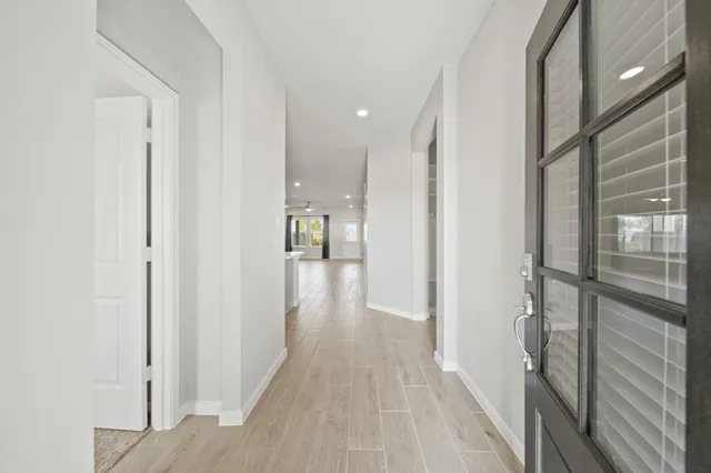 a view of hallway with wooden floor