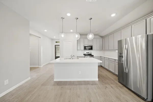 a large white kitchen with a large window