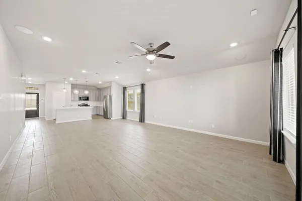 a view of an empty room with a kitchen