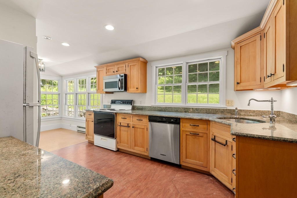 495 Edmands Road Framingham, MA 01701 - Photo 19 of 39 a kitchen with stainless steel appliances granite countertop a stove a sink and a microwave