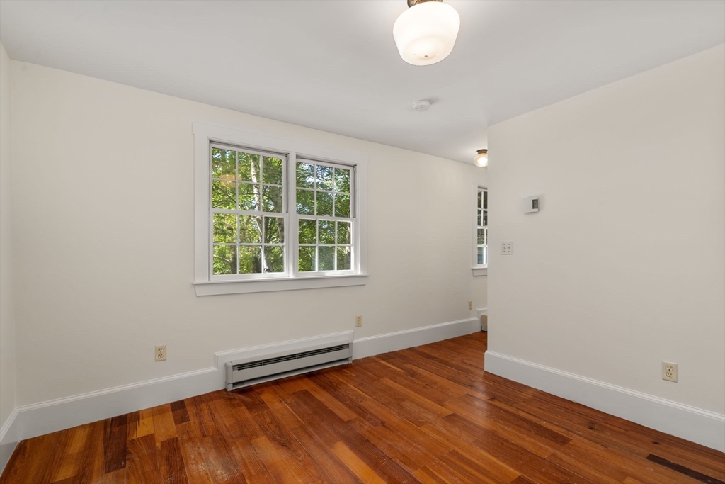 495 Edmands Road Framingham, MA 01701 - Photo 29 of 39 an empty room with wooden floor and windows