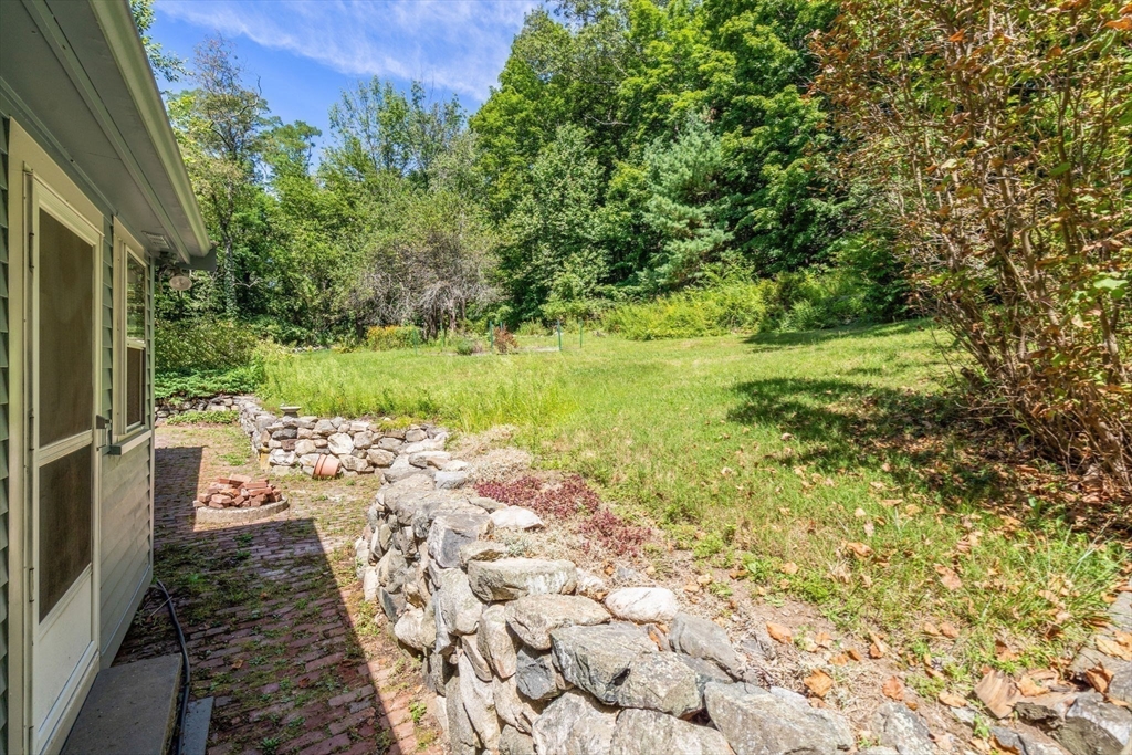 495 Edmands Road Framingham, MA 01701 - Photo 8 of 39 a view of a yard with plants and large trees