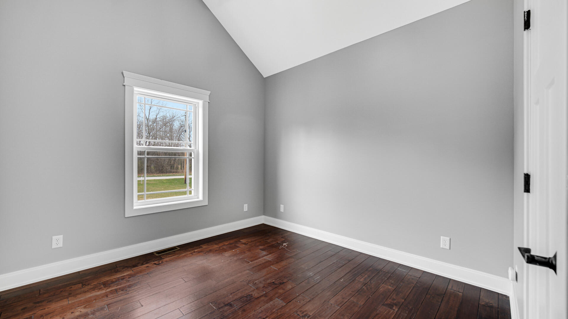 10427 North 600th Street West Demotte, IN 46310 - Photo 14 of 26 an empty room with wooden floor and windows