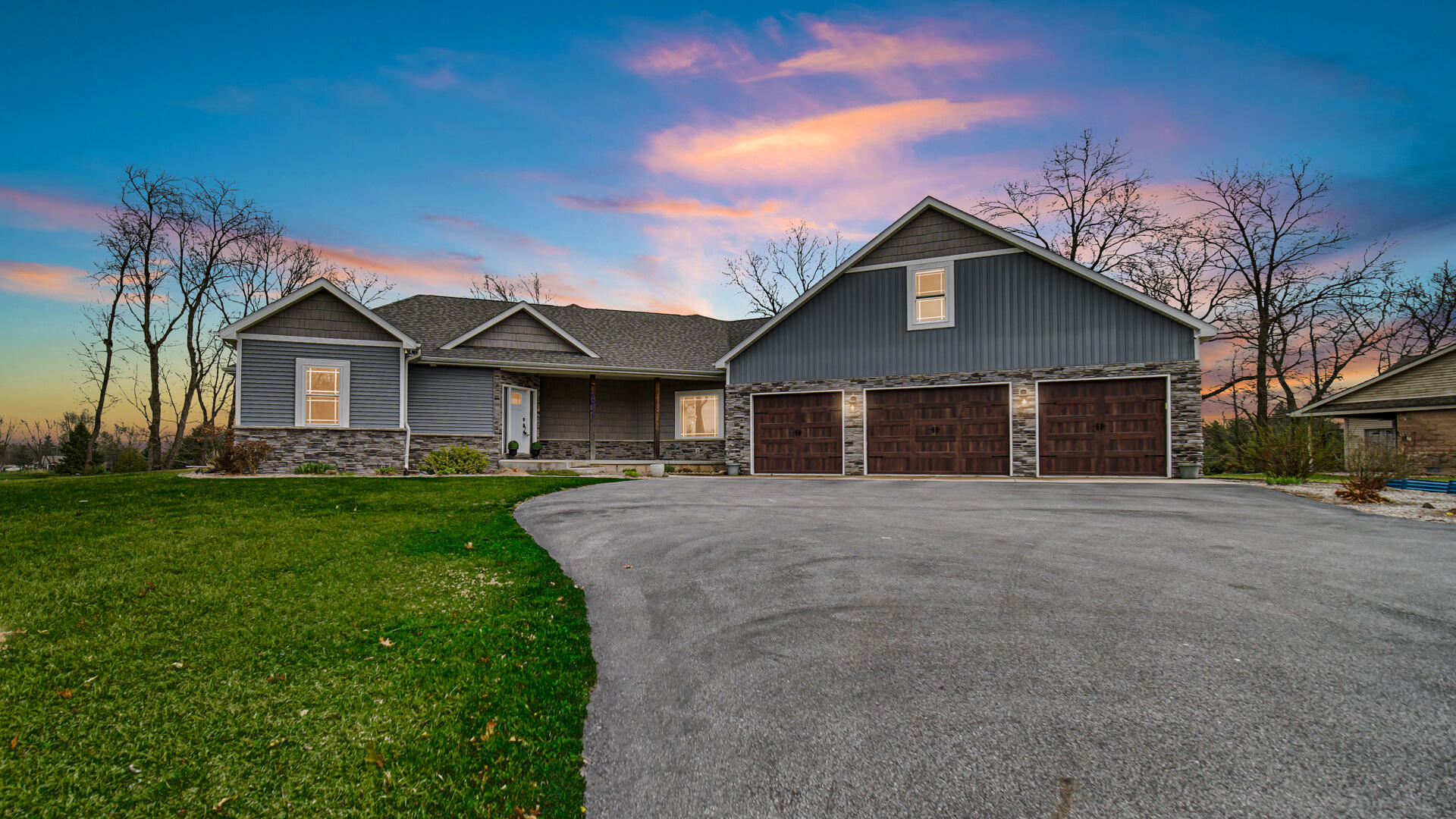 10427 North 600th Street West Demotte, IN 46310 - Photo 22 of 26 a front view of a house with a yard and garage