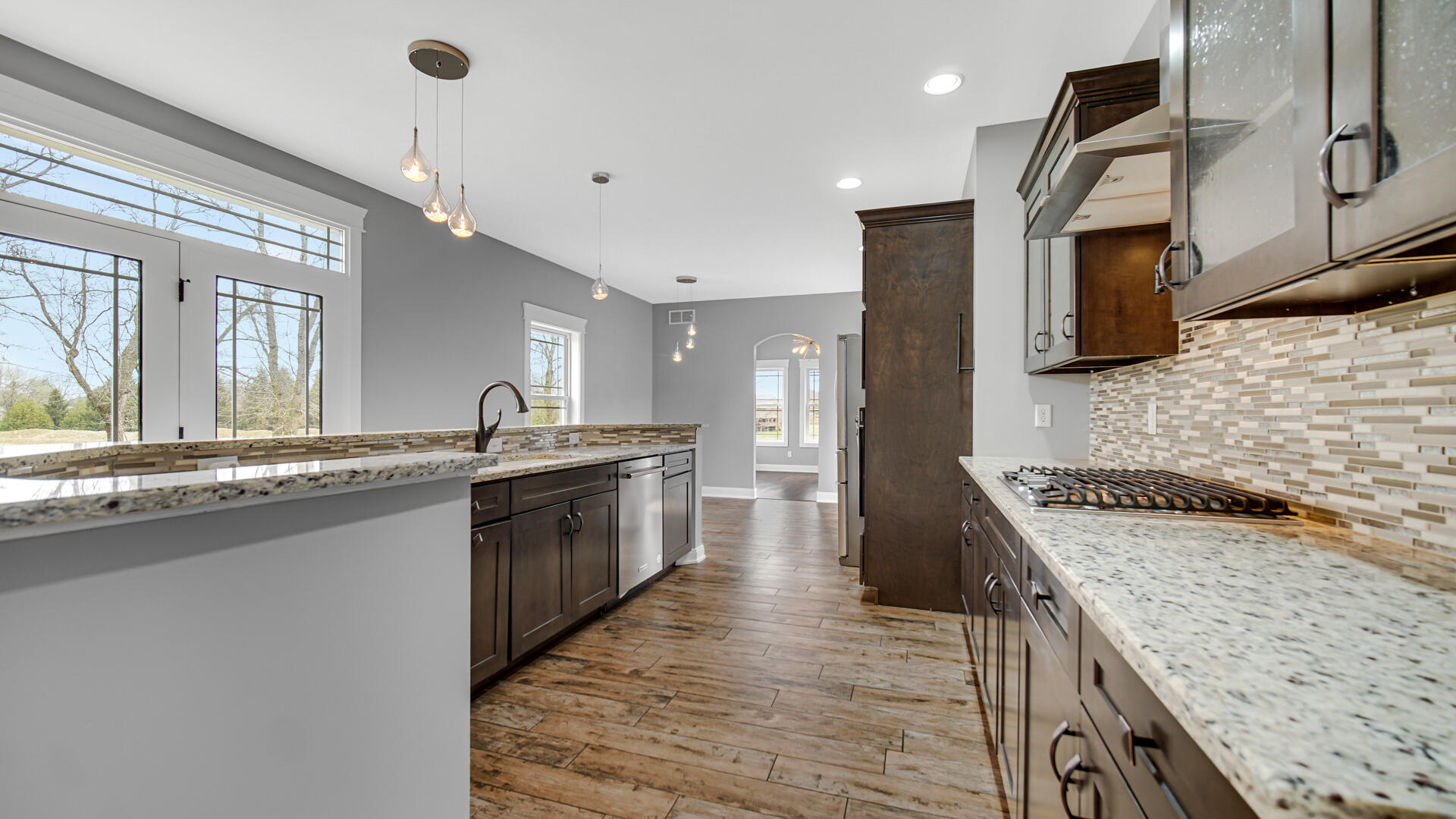 10427 North 600th Street West Demotte, IN 46310 - Photo 5 of 26 a large kitchen with granite countertop a sink and a stove