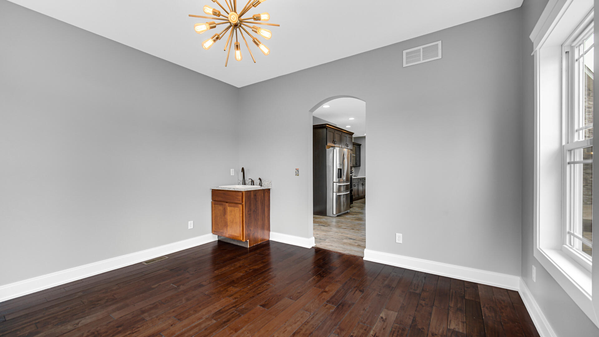 10427 North 600th Street West Demotte, IN 46310 - Photo 9 of 26 an empty room with wooden floor and windows