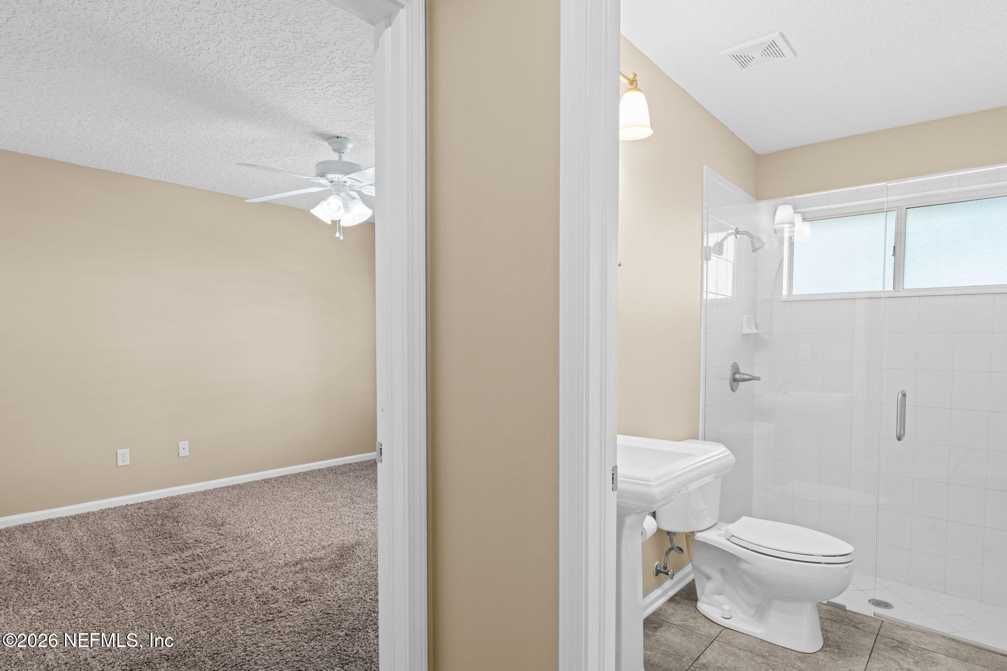 1600 Spring Water Court Fleming Island, FL 32003 - Photo 38 of 85 a bathroom with a toilet sink and a mirror