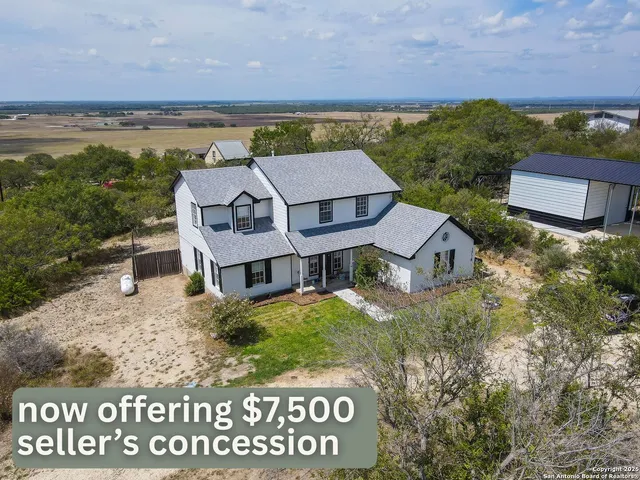 an aerial view of residential houses with outdoor space and street view
