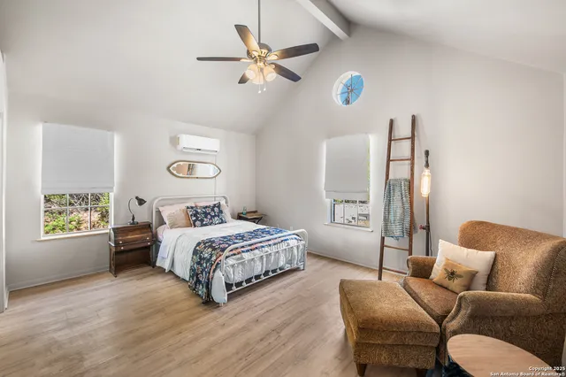 a living room with a bed furniture and a window