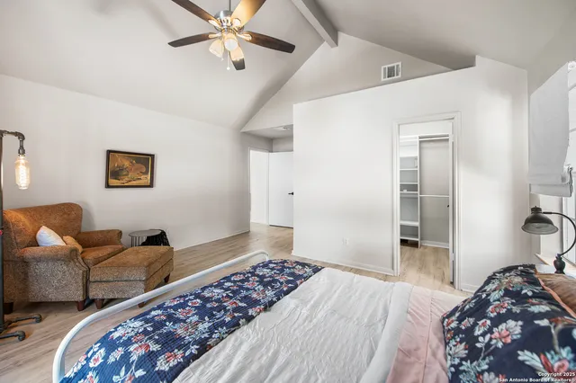 a bedroom with furniture and a rug