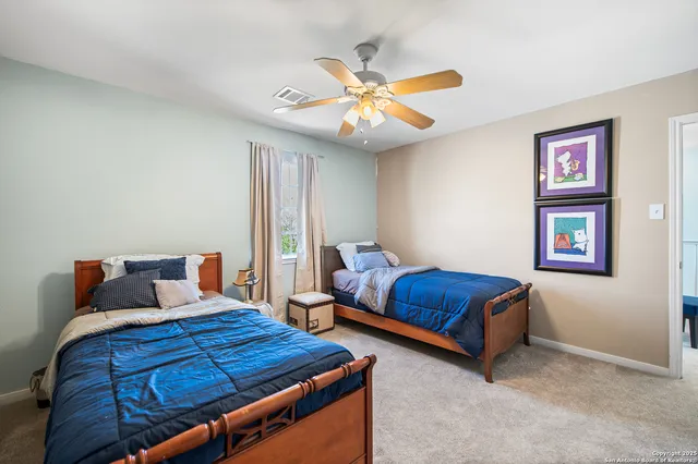 a bedroom with bed and a chandelier