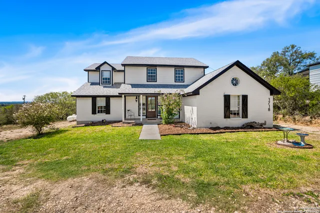 a front view of a house with a garden and porch