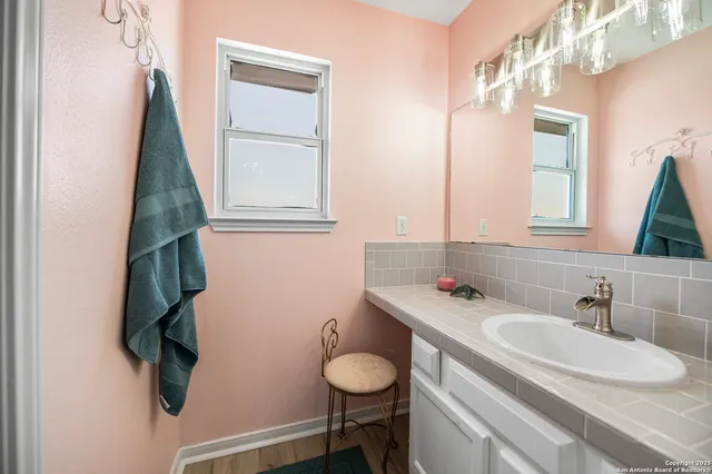a bathroom with a double vanity sink and a mirror
