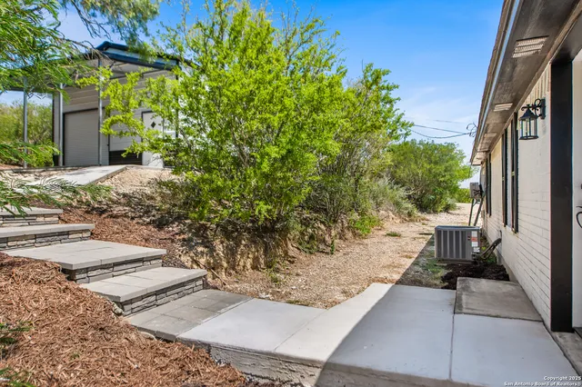 a roof deck with couch and chairs