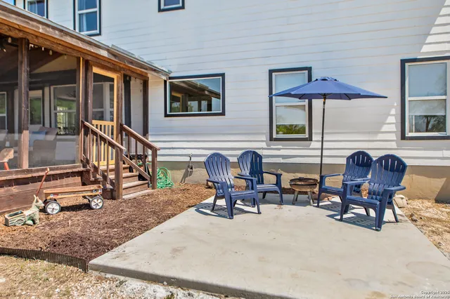 a view of a house with a bench in the patio