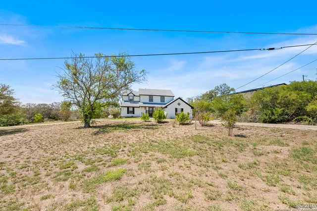 a view of a house with a yard and garage