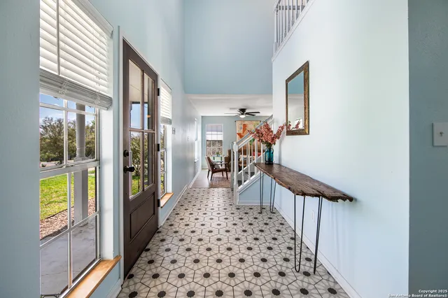 a view of a hallway with wooden floor and windows