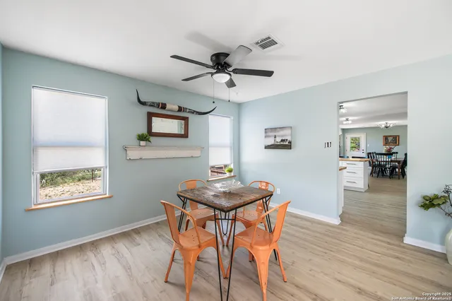 a view of a dining room with furniture and wooden floor