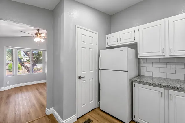 a white refrigerator freezer sitting inside of a kitchen