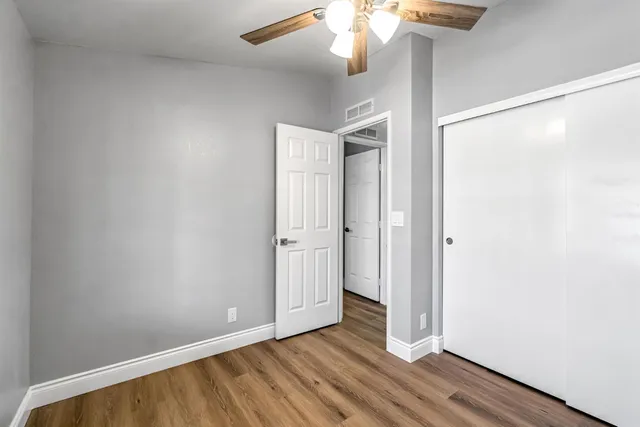 a view of an empty room with wooden floor