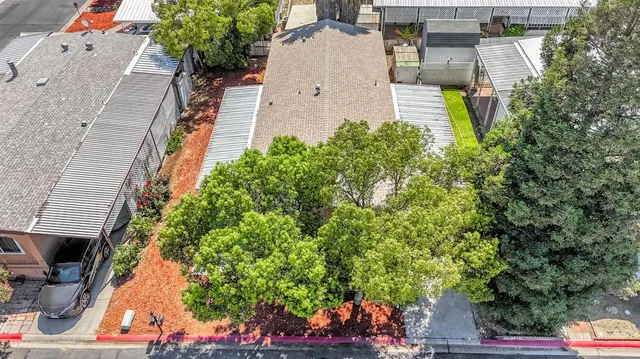 an aerial view of a house with a yard and garden