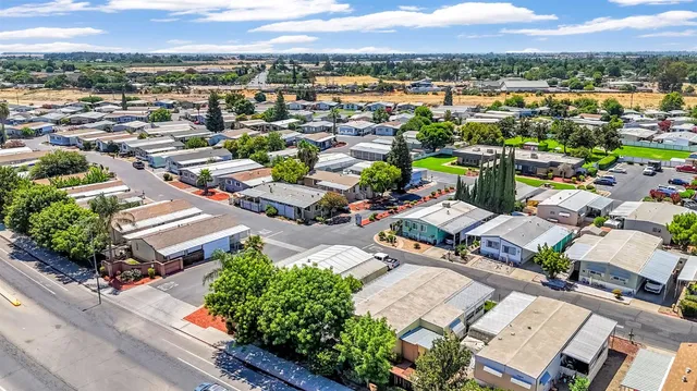 an aerial view of a swimming pool and mountain view in back