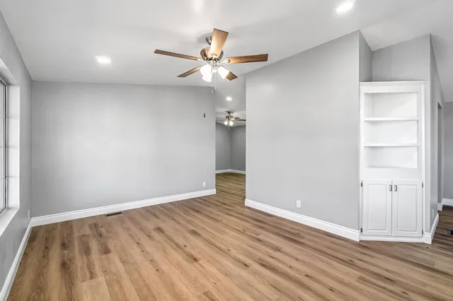 wooden floor in an empty room with a window