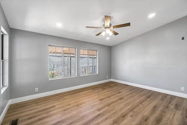 wooden floor in an empty room with a window
