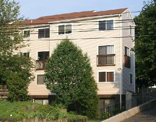 8 Fort Point Street, Unit 1 Norwalk, CT 06855 - Photo 1 of 1 a front view of a house with a yard
