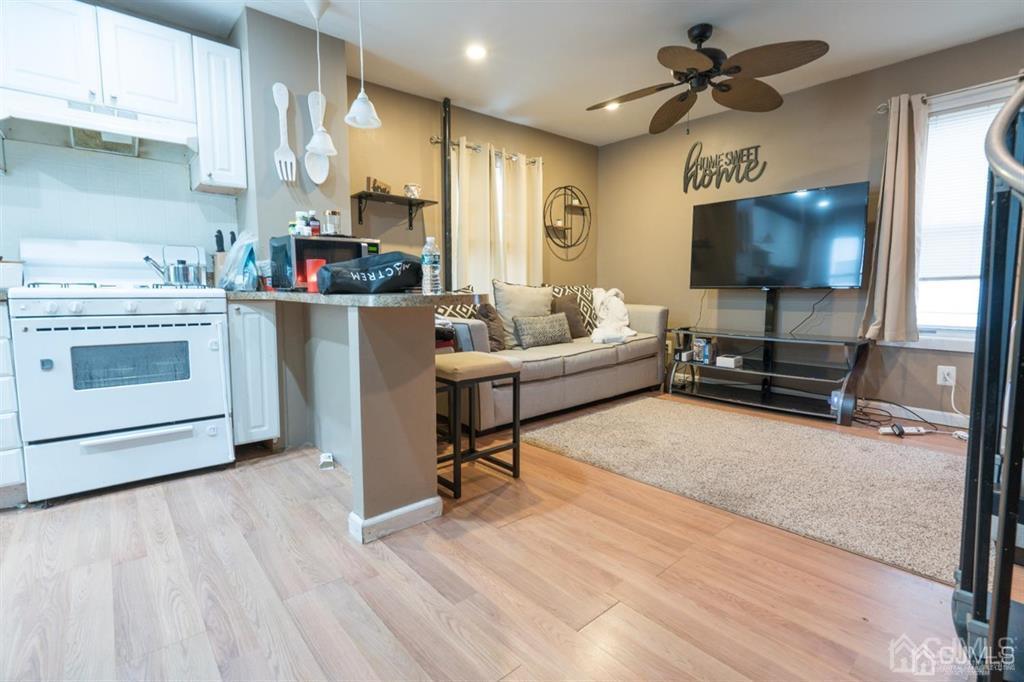 77 Center Street Perth Amboy, NJ 08861 - Photo 11 of 28 a living room with furniture and a flat screen tv