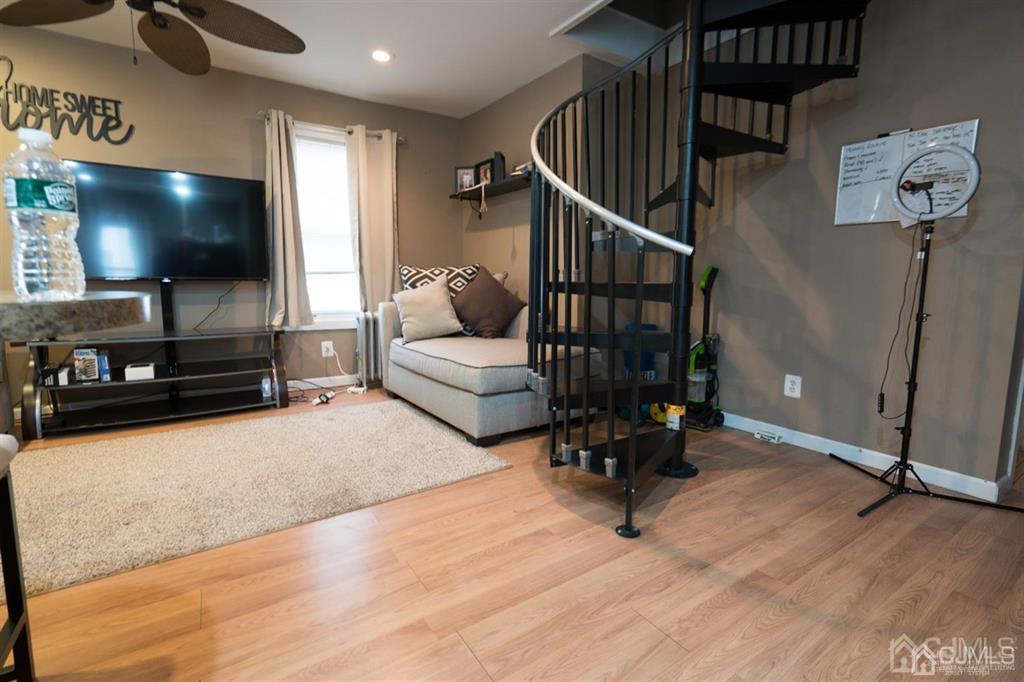 77 Center Street Perth Amboy, NJ 08861 - Photo 12 of 28 a living room with furniture and a flat screen tv