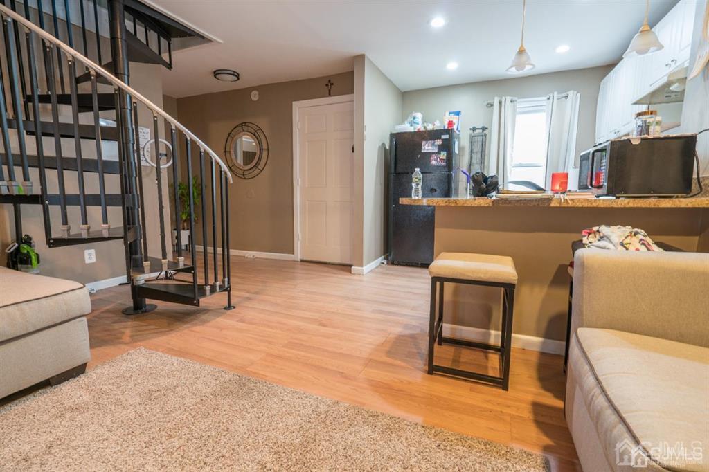77 Center Street Perth Amboy, NJ 08861 - Photo 13 of 28 a lobby with furniture and a flat screen tv