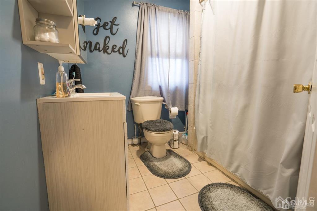 77 Center Street Perth Amboy, NJ 08861 - Photo 15 of 28 a bathroom with a sink and toilet