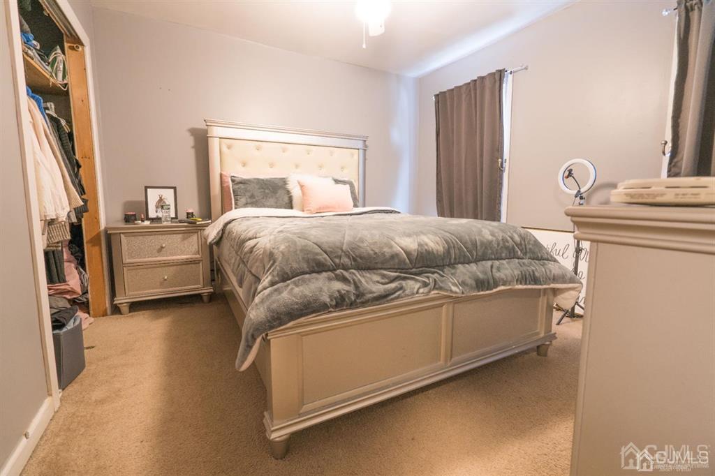 77 Center Street Perth Amboy, NJ 08861 - Photo 16 of 28 a bedroom with a bed and a potted plant