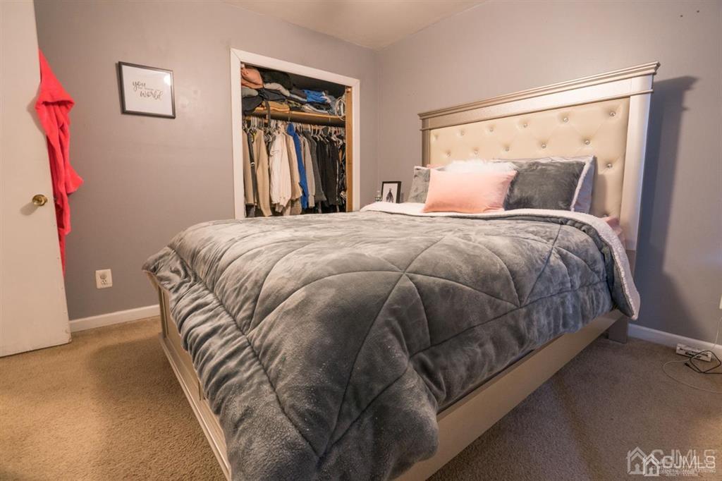 77 Center Street Perth Amboy, NJ 08861 - Photo 17 of 28 a bed sitting in a bedroom next to a window
