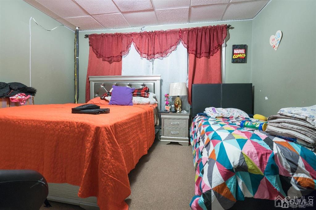 77 Center Street Perth Amboy, NJ 08861 - Photo 20 of 28 a bedroom with a bed and a painting on the wall