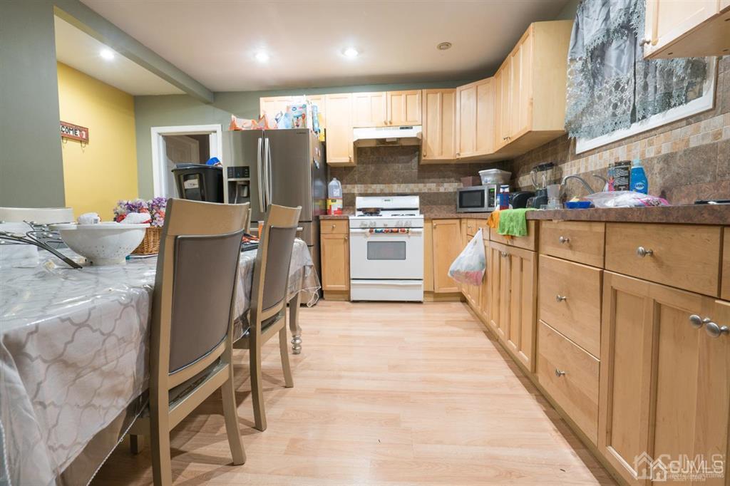 77 Center Street Perth Amboy, NJ 08861 - Photo 22 of 28 a kitchen with stainless steel appliances kitchen island granite countertop a sink and cabinets