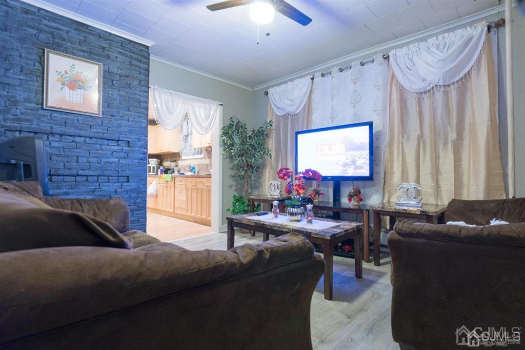 77 Center Street Perth Amboy, NJ 08861 - Photo 28 of 28 a living room with furniture and a flat screen tv