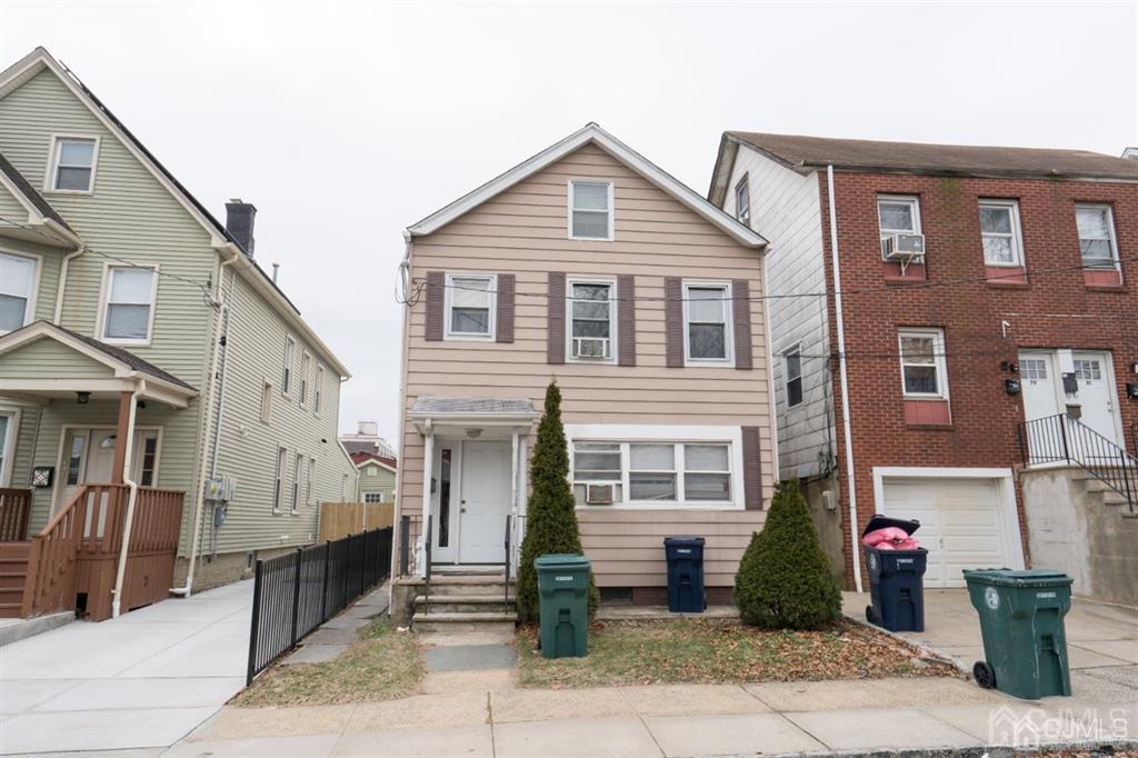 77 Center Street Perth Amboy, NJ 08861 - Photo 3 of 28 a front view of a house with a porch