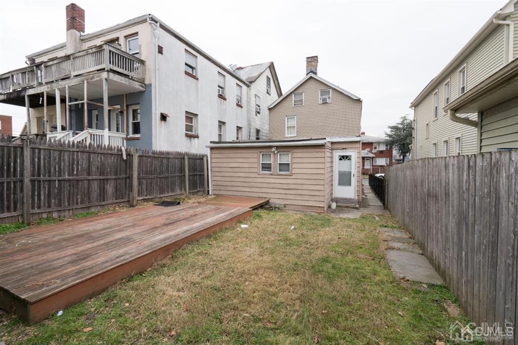 77 Center Street Perth Amboy, NJ 08861 - Photo 7 of 28 a view of a house with wooden fence