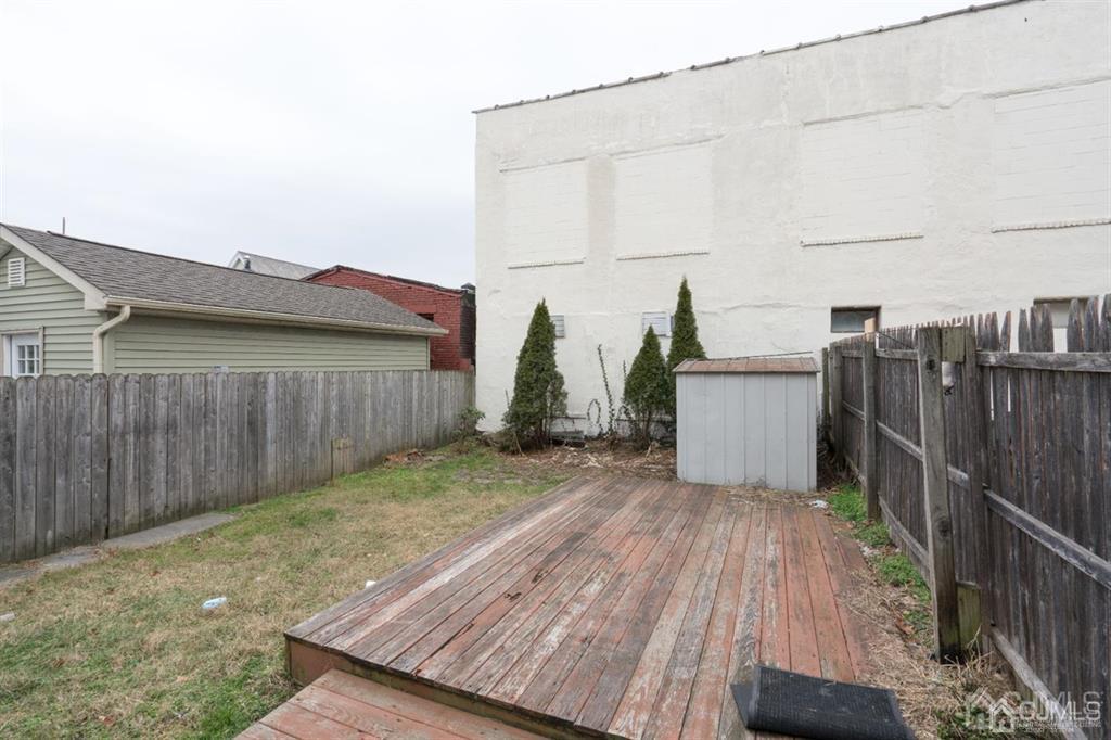 77 Center Street Perth Amboy, NJ 08861 - Photo 8 of 28 a view of a backyard with wooden fence