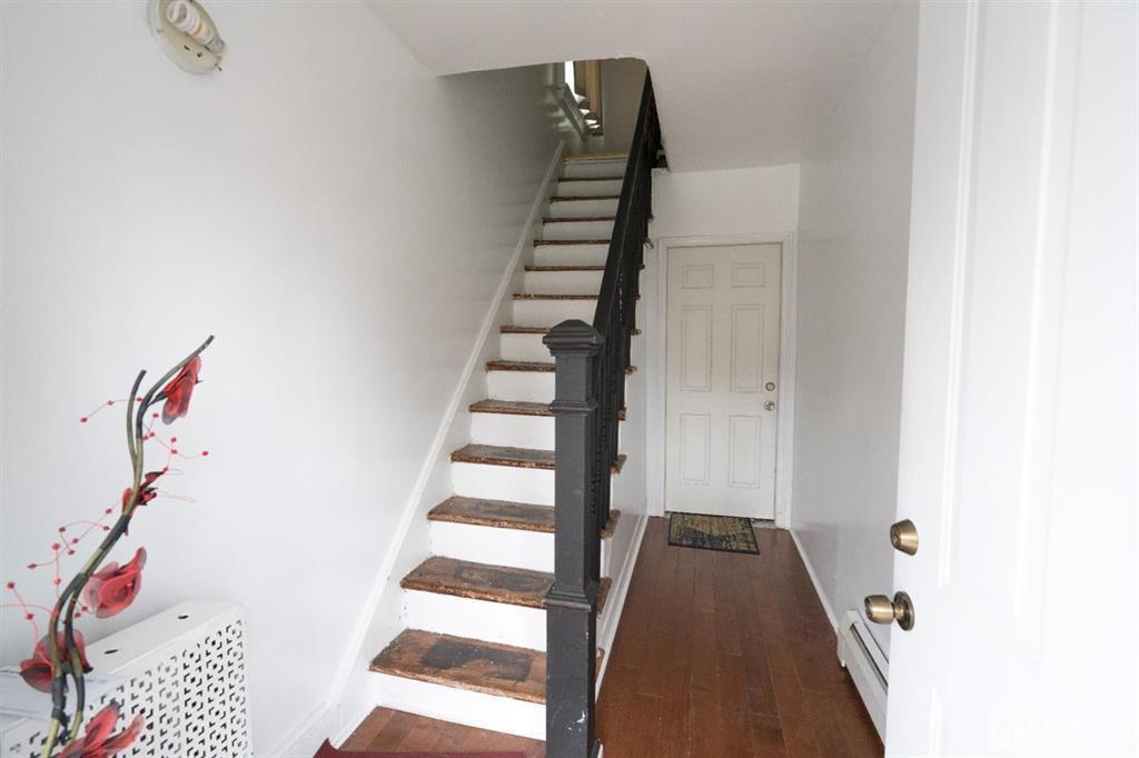 77 Center Street Perth Amboy, NJ 08861 - Photo 9 of 28 a view of entryway with stairs and wooden floor