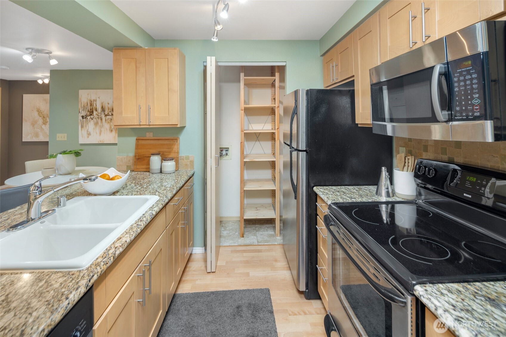 6960 California Avenue Southwest, Unit A308 Seattle, WA 98136 - Photo 11 of 22 a kitchen with a stove sink and refrigerator