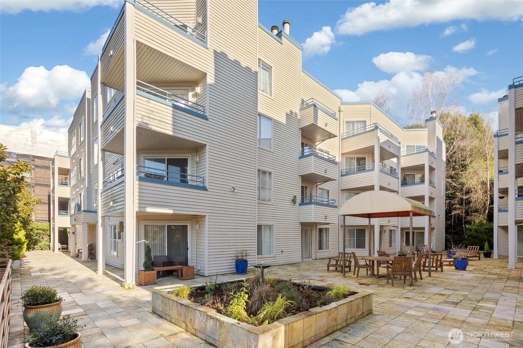 6960 California Avenue Southwest, Unit A308 Seattle, WA 98136 - Photo 18 of 22 a view of a building with a patio