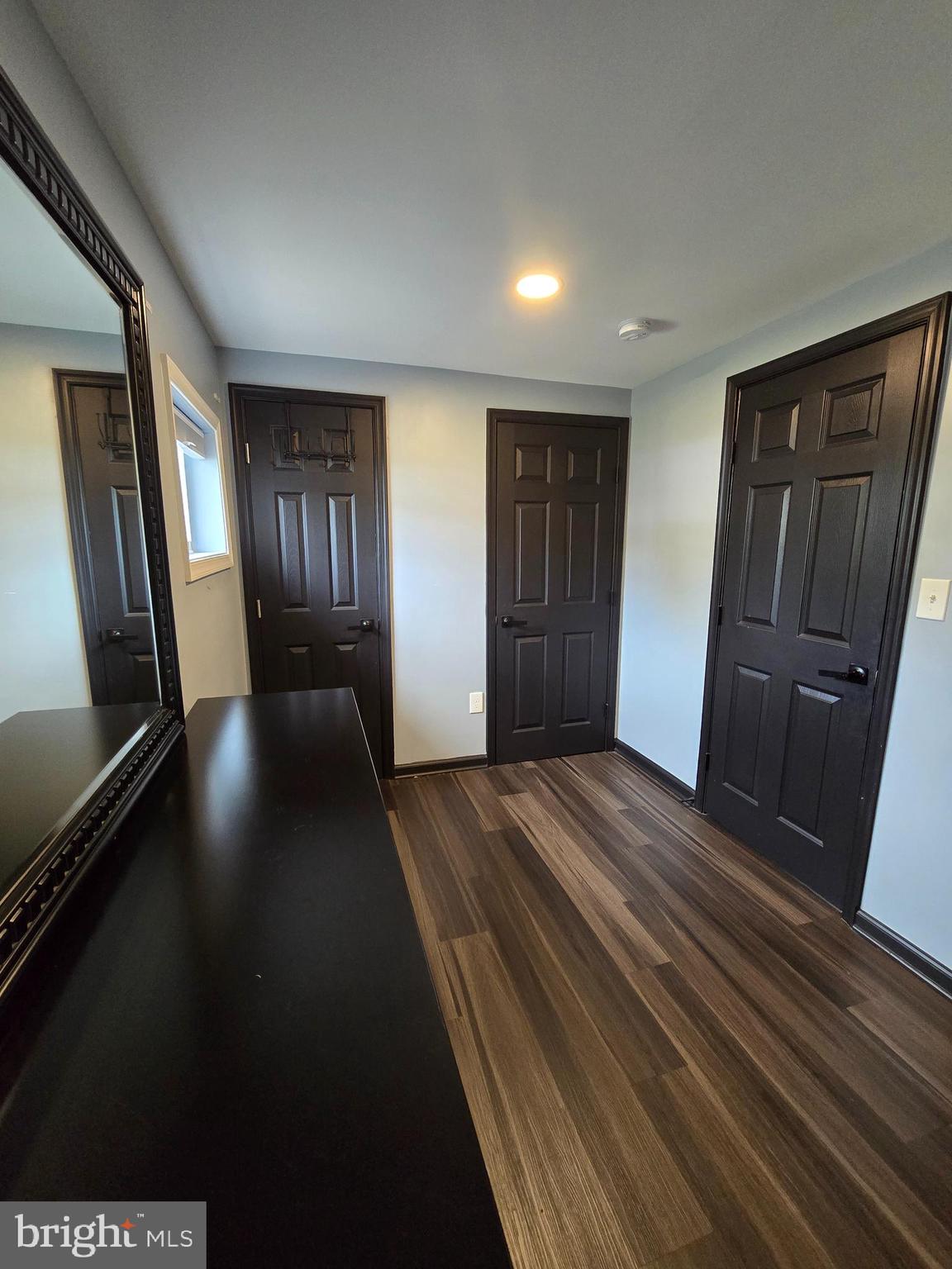 7513 Saffron Court Hanover, MD 21076 - Photo 36 of 42 a view of an empty room with wooden floor and a window