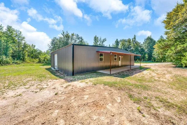 a backyard of a house with wooden fence and roof