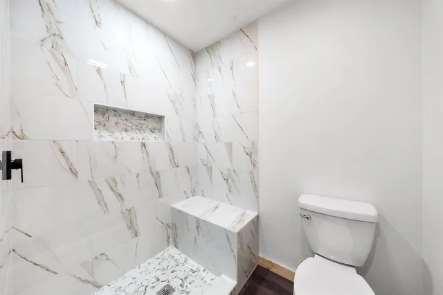 a white toilet sitting next to a bathroom sink